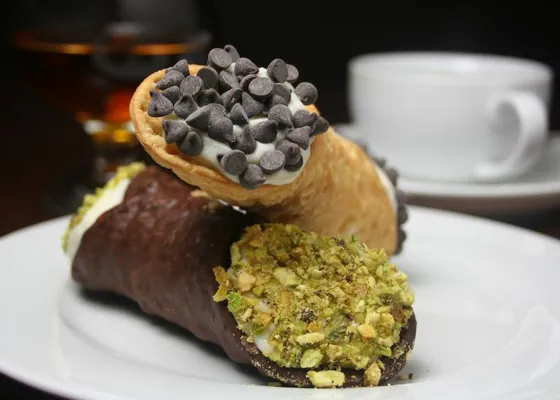 Cannoli with ricotta filling, chocolate chips and chopped pistachios