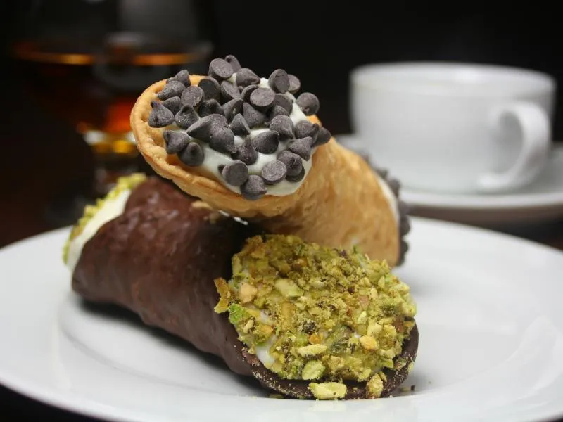 Cannoli with ricotta filling, chocolate chips and chopped pistachios