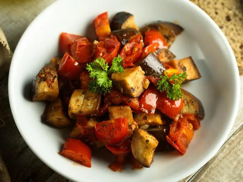 A bowl of caponata with eggplant and red peppers