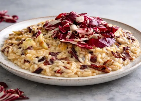 Creamy risotto flecked with cooked red radicchio and topped with a mound of fresh burgundy and white radicchio strips